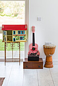 Dolls house and guitar with drum in Guildford home, Surrey, UK