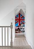 View through landing doorway to bright Union Jack in boy's room of Guildford home Surrey UK