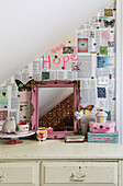 Pink framed mirror with text and butterfly wallpaper in girls room in Guildford, Surrey, UK