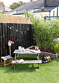 Children's furniture and toys with astro turf lawn in garden of Cardiff home, Wales, UK