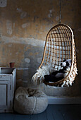 Panda in hanging chair with unplastered walls in Somerset home UK
