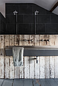 Modern showerheads with rustic weatherboard in Somerset home UK