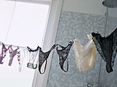 Clothes line of sexy lingerie in a bathroom shower