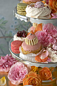 Individual cakes on a cake stand with flower decorations