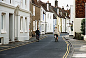 Mother and son cycling up the high street in Deal 