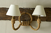 Two cream lampshades with a rope fitting