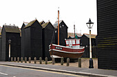 Fishing boat and old sea huts in historic Hastings