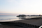 Hastings pier and shingle beach at twilight