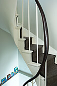 Staircase detail with dark wood handrail in Hastings beach house England UK