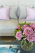 PInk roses on coffee table in living room of Canterbury home England UK