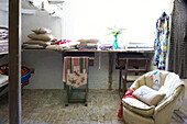 Fabric samples and cushions on workbench in Suffolk home, England, UK