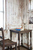 Dark wooden desk and chair in corner of Aldeburgh beach house Suffolk England UK