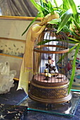 Artificial birds in a bird cage in Massachusetts home, New England, USA