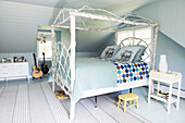 White four poster bed with light blue and spotted quilts in Berkshires home, Massachusetts, Connecticut, USA