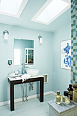 Wash basin below mirror in light blue bathroom of Berkshires home, Massachusetts, Connecticut, USA