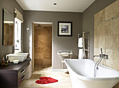 Neutral grey bathroom with red heart shaped bath mat