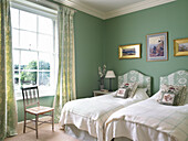 Pastel green twin bedroom in Lincolnshire country house, England, UK