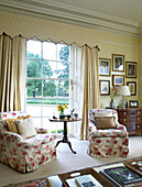 Matching floral chairs at window of Lincolnshire country house, England, UK