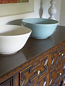 White and blue bowls on antique sideboard in Gloucestershire farmhouse, England, UK