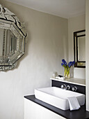 Recessed wash basin with silver framed mirror in city of Bath home Somerset, England, UK