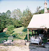 English country garden with canvas tent awning and garden furniture