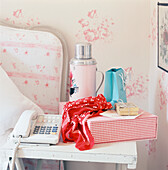 Feminine bedside table with telephone and personal belongings