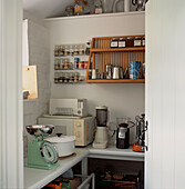 Walk in storage pantry with condiments utensils and kitchenware