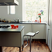 Contemporary kitchen with wooden floor and stool
