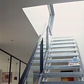View up a metal staircase in an open plan contemporary apartment