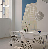Contemporary coordinating dining room with stone floor white dining table and chairs and turquoise and white decor