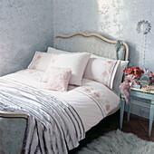 Pretty feminine girls bedroom with upholstered vintage style double bed