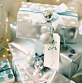 Decorative wrapped Christmas presents with baubles and name tags