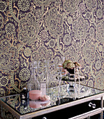 Bedroom with bold patterned wallpaper and mirrored dressing table