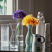 Detail of ceramic vases and glassware on a tabletop