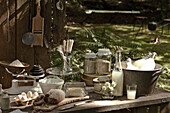 Cooking ingredients and a bucket of lemonade on wooden table in garden, UK