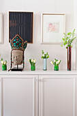 Single stem flowers in dining room detail of contemporary London home England UK