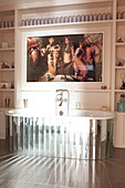 Modern art above mirrored bath tub in contemporary London home England UK