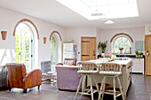 Arched doorways and windows in open plan kitchen living room of Surrey cottage England UK