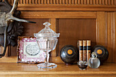Collection of ornaments on wooden Arts and Crafts style mantlepiece in Haslemere home, Surrey, UK