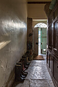 Original stone floor and wellington boots in historic Somerset country house UK