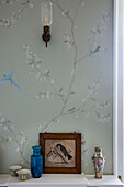 Floral wallpaper with birds and vintage ornaments in historic Somerset country house UK