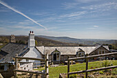 Garden fence and rooftops of rural stone farmhouse in Dartmoor Devon England UK