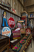 Collection of road signs and crates in Dartmoor barn Devon England UK
