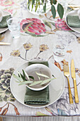 Leaves and green napkins with floral tablecloth in London home UK