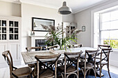 Tall grasses on dining table at sash window in Clevedon home Somerset, UK