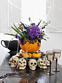 Halloween centrepiece with skulls and wineglasses on table Brighton, East Sussex UK