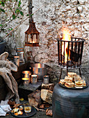 Lit brazier and metal lanterns with firewood and whiskey Brighton, East Sussex UK
