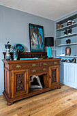 Wooden antique sideboard in light blue double reception room of Farnham Home UK