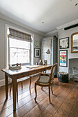 Wooden desk and chair at window in Winchester home UK