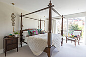 Carved four poster bed in sustainable newbuild Highgate London UK